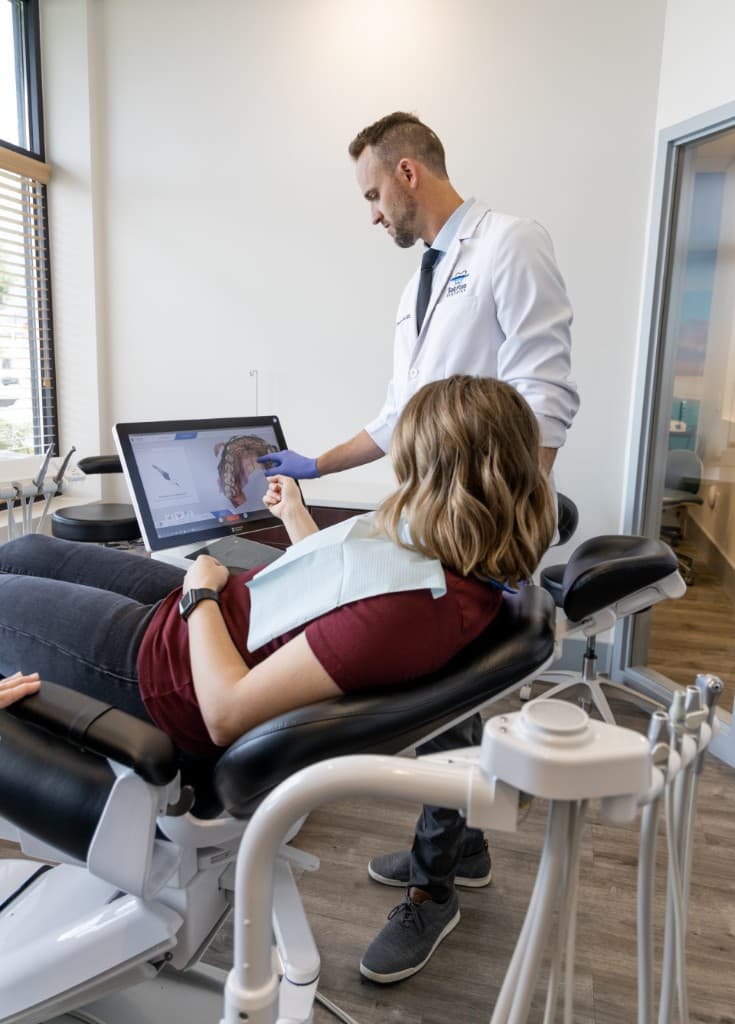 Dentist and patient reviewing a CEREC digital scan for same day crown planning